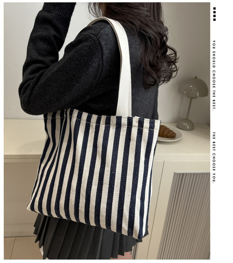 The new cross-border vertical striped commuter tote bag, hand-held shoulder bag, is fashionable and has a large capacity. It features an InS-style simple letter sail Application Scenario