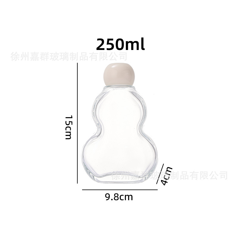 Botellas de vidrio transparentes de vino de fruta, bebida de jugo de fruta, té de leche, vino de fruta auto-elaborado, engrosado envasado, botellas vacías en stock al por mayor