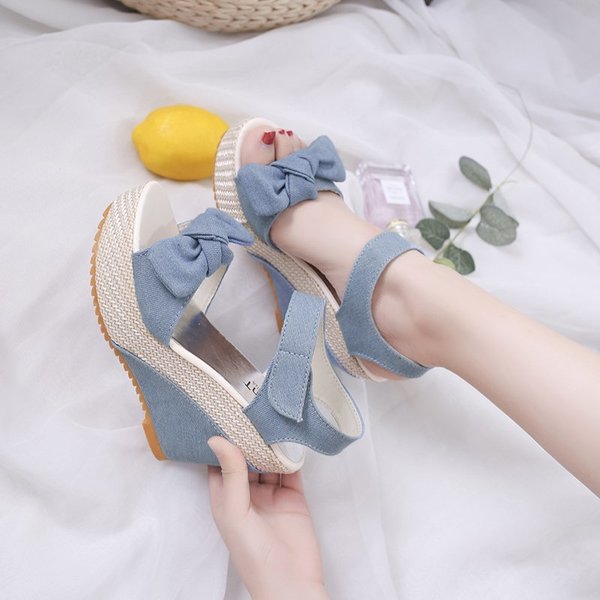 Summer fashionable cute sandals with a strap with bow wedge heel…