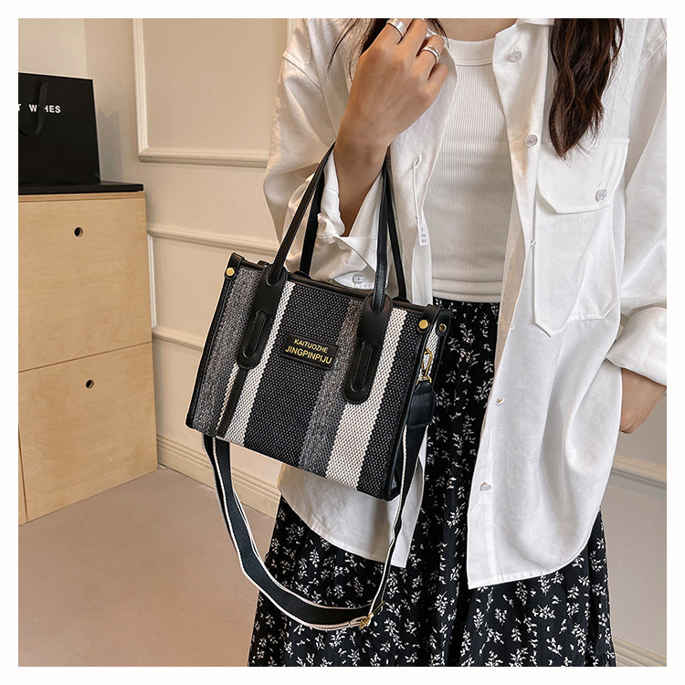 Bolso Tote portátil a rayas de color de contraste de lona para mujer 2024 nueva textura de moda transfronteriza bolso de mensajero de un solo hombro