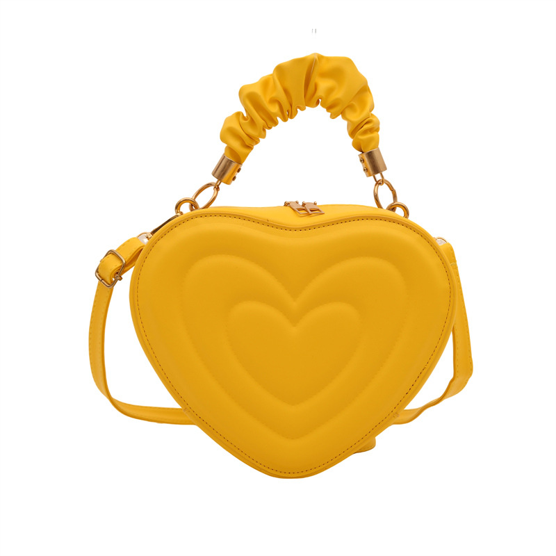 2024 otoño y invierno de mujeres nuevas caramelo de cáscara dura bolso de hombro de color corazón bolso de moda bolso de amor amor amor impresión