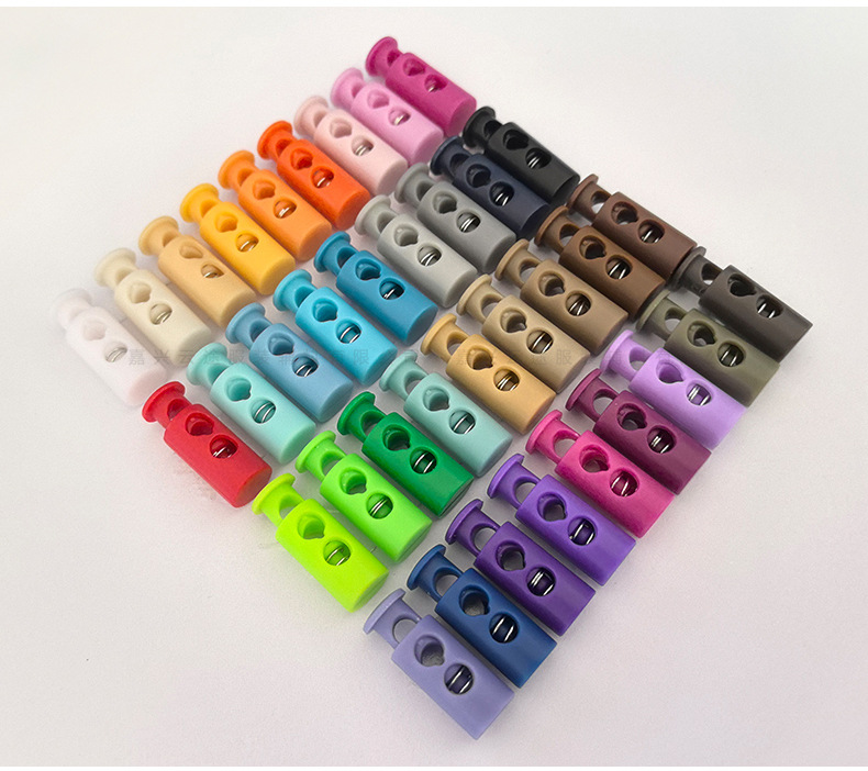 Kunststoff-Farbfedern-Schnallenverschluss, zweilöchrige zylindrische Seilschnalle, Daunenjacken-Verstellschnalle, Elastic-Stopper, Rutschfester Verschluss, Glockenform-Schnalle
