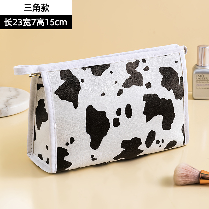 Patrón de vaca PU bolsa de cosméticos impermeable de gran capacidad de alto aspecto portátil avanzado bolsa de almacenamiento cuidado de la piel bolsa de lavado al por mayor