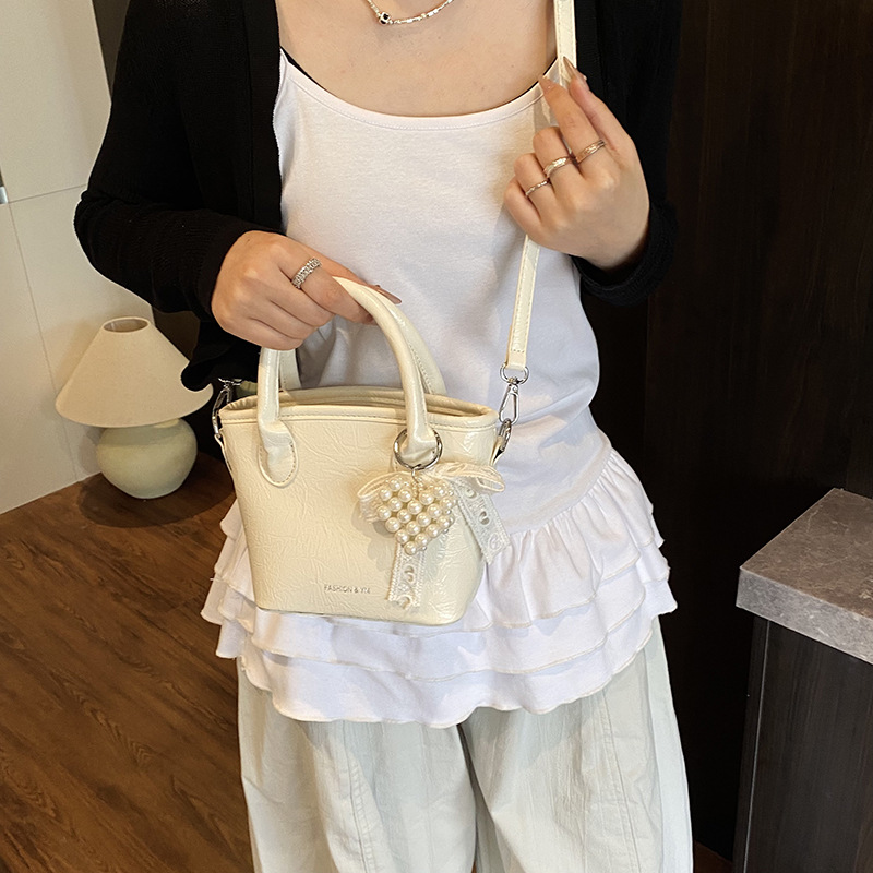 Bolso de cubo de mano súper caliente de comercio exterior 2025 nuevo bolso de hombro de tendencia salvaje de moda bolso de mensajero de nicho de alta gama de moda