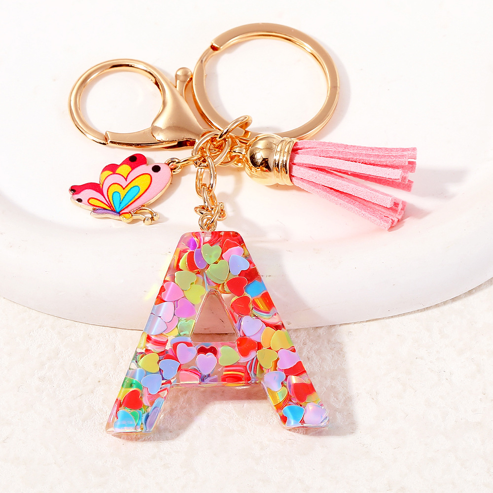 2024 puntos transfronterizos de resina de sequilla rosa 26 letras inglesas llavero colgante mariposa fringe accesorios