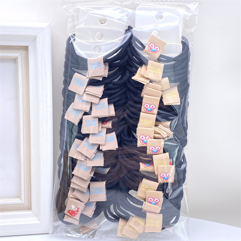 Caqui fresa oso etiqueta de tela anillo de pelo rojo leche té color 03 amor banda de goma lazo de pelo de las mujeres 2 yuanes tienda física