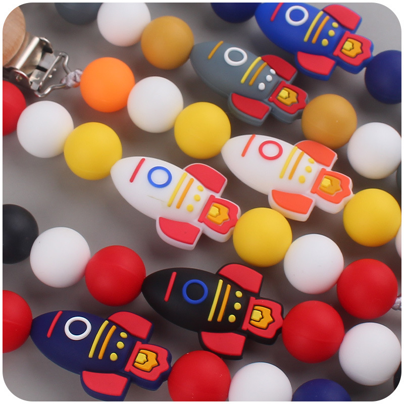 Nuevos suministros para bebés cohete de dibujos animados pequeño mordedor creativo DIY silicona mordedura molar Cadena de pezón cadena anti-caída