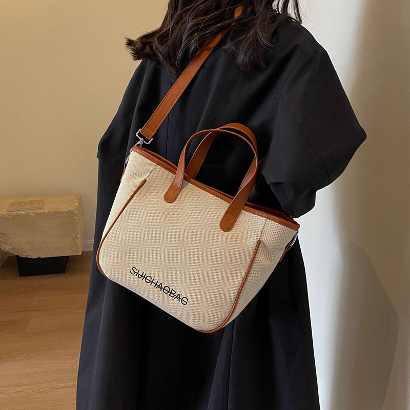 Estilo coreano de moda de contraste de color lienzo bolsa de mano portátil para las mujeres 2023 transfronteriza nueva textura de alto grado de hombro bolsa de mensajero