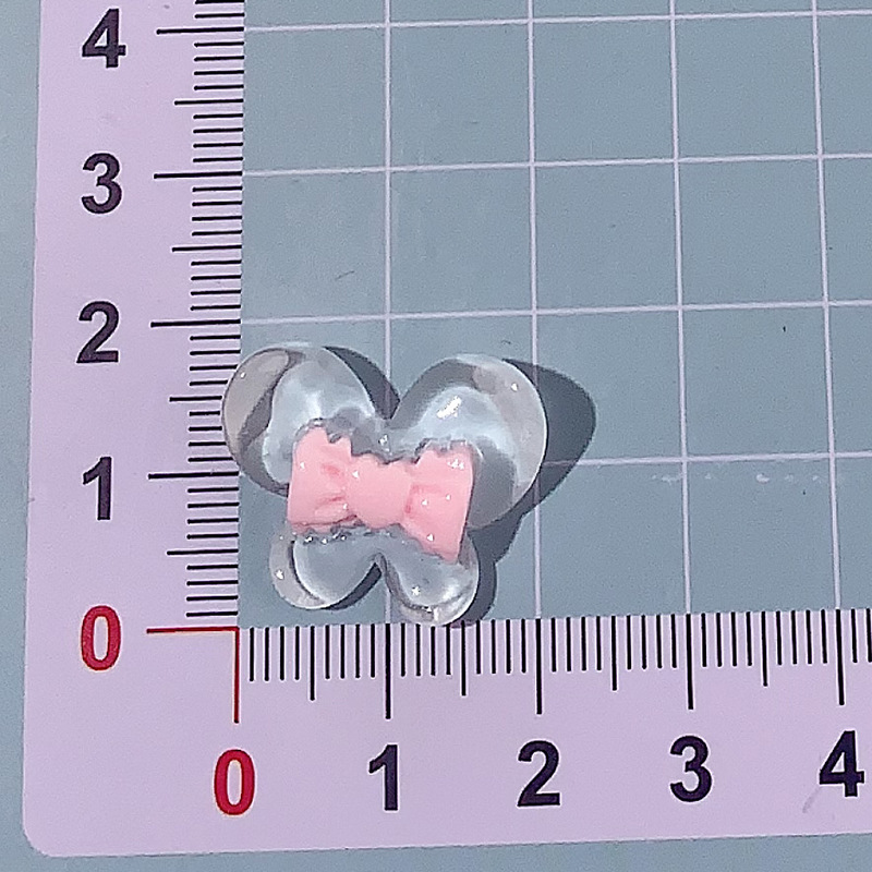 Nuevo color transparente mariposa arco DIY accesorios de resina pegamento crema caja de teléfono móvil adornamiento de pelo agujero material de parche de zapatos agujero