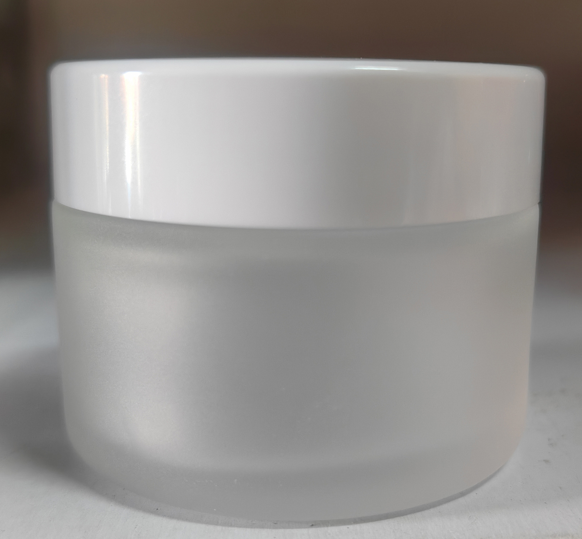 Botella de crema de vidrio al por mayor botella de crema de ojos esmerilada 100g cubierta de grano de madera cosmética sub-botella