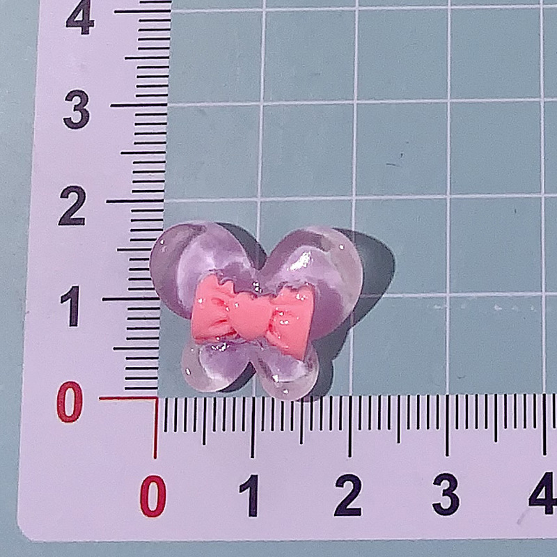 Nuevo color transparente mariposa arco DIY accesorios de resina pegamento crema caja de teléfono móvil adornamiento de pelo agujero material de parche de zapatos agujero