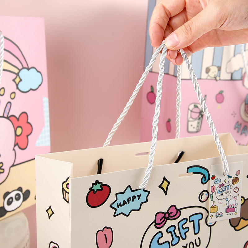 Bolsas de regalo de dibujos animados en bolsas de regalo de mano de tarjeta blanca bolsas de regalo de mano de estudiantes bolsas de regalo de mano