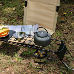 Foldable outdoor picnic table with extendable steel mesh tabletop, stove rack stand, extended tabletop, and portable metal tea table.