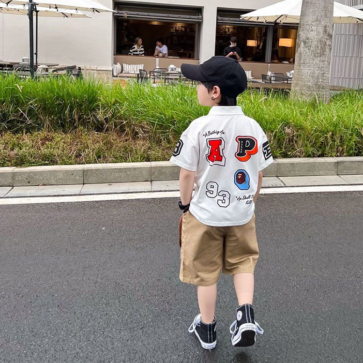 2023 Summer New Boys' Trendy Brand Letter Polo Shirt Small and Medium-sized Children's Black and White Short-sleeved T-shirt Lapel Top Trendy