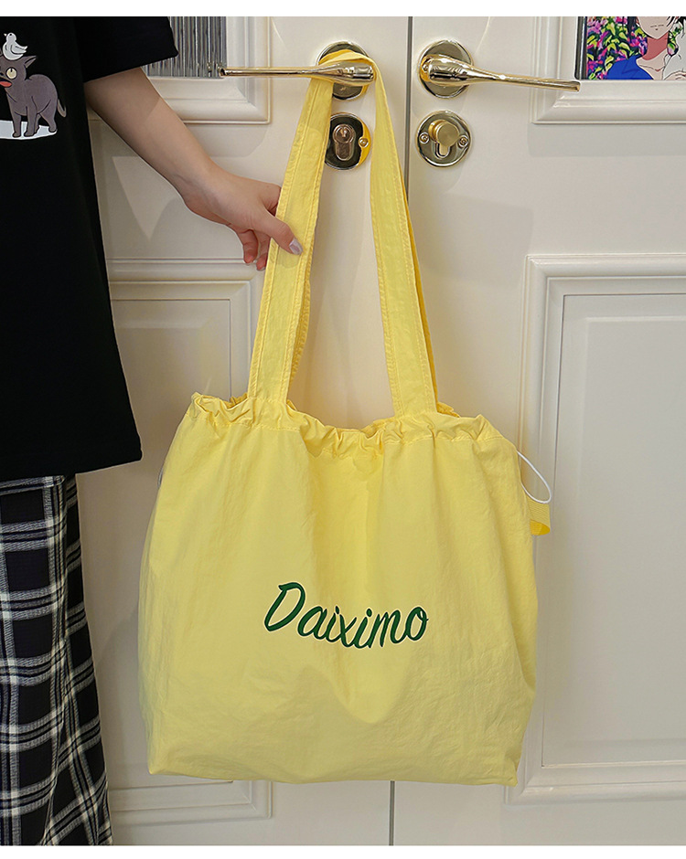 Solid color large-capacity tote bag 2025 bestseller, fashionable commuting lightweight handbag, laid-back style drawstring nylon bag for women undefined