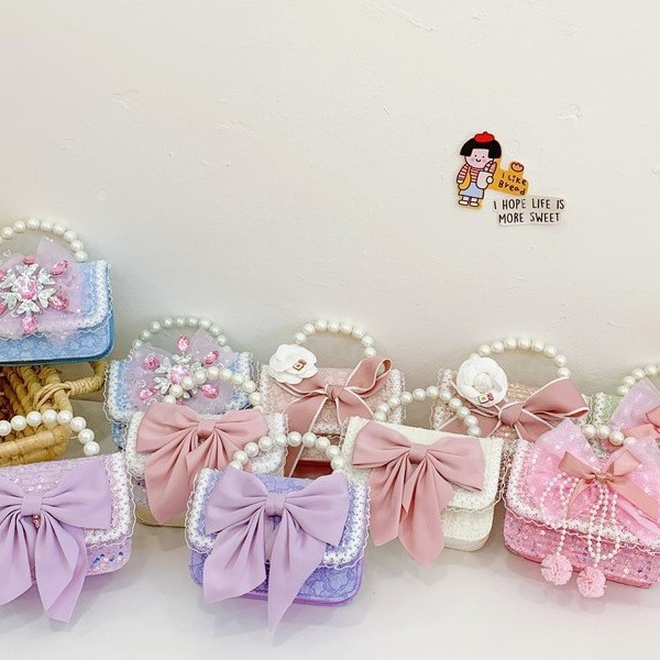 Otoño y invierno coreano arco camellia bolsas de niños de encaje de mano perlas bolsas mochilas para niñas de jardín de infantes