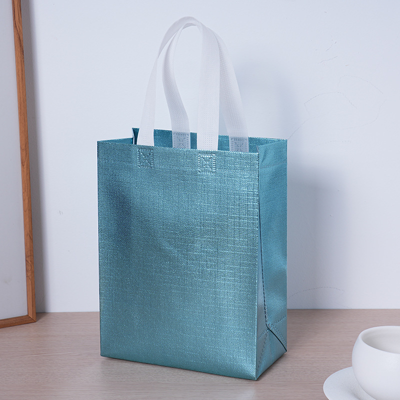 Bolsa de regalo especial de fiesta transfronteriza pequeña película de aluminio en relieve no tejido bolsas láser personalizadas no tejidas
