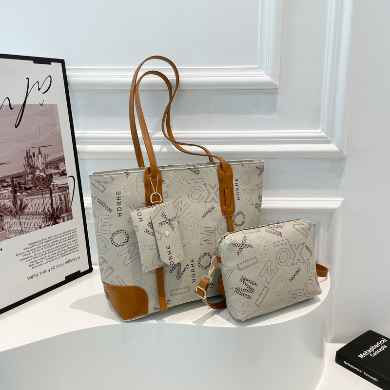 Bolsa de impresión de letras retrógradas para mujeres 2025 primavera nueva bolsa de hombro de gran capacidad bolsa de moda portátil brazo