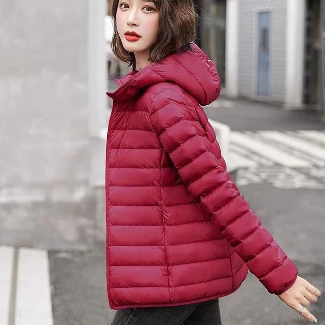 Off-season plus-size down jacket for women, featuring a stand-up collar, hood, Korean-style design, a cute and slim fit, lightweight fabric, and a loose, long-sleeved outerwear style Off-season plus-size down jacket for women, featuring a stand-up collar, hood, Korean-style design, a cute and slim fit, lightweight fabric, and a loose, long-sleeved outerwear style