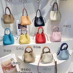 春夏の新型2024韓国の小衆の麦の包みは手提げのバケツの包みの本革の高級感の精巧な斜めの包みを編みます。