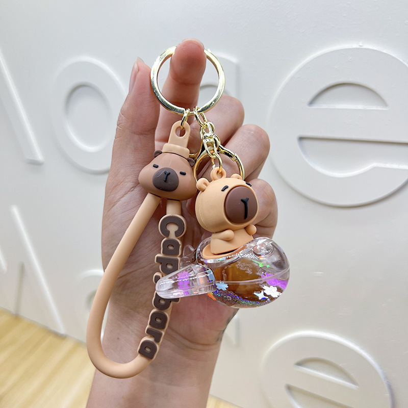 Botella creativa de aceite flotante Capibara Dolphin Keychain bolsos de automóviles exquisitos colgantes de arena flotante regalos al por mayor