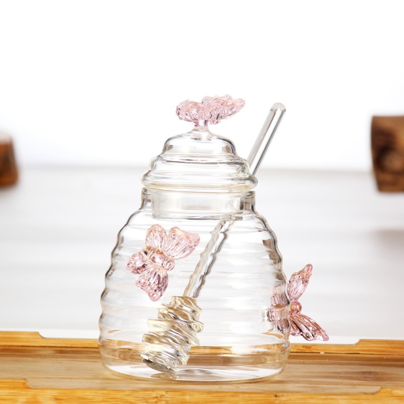 Hermoso y creativo de grado alimenticio vidrio transparente latas de miel de almacenamiento jarra de jelly frasco de miel doméstica con barra de agitación