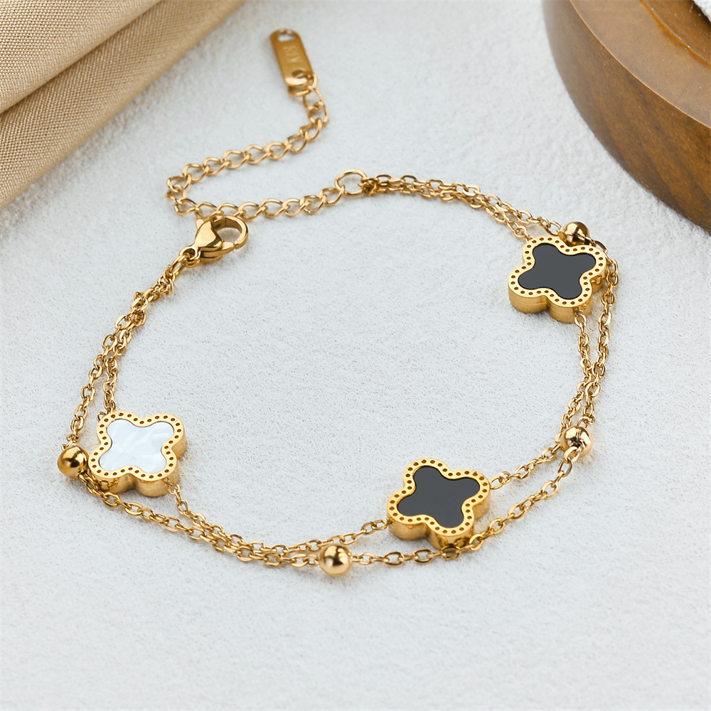 Ventas transfronterizas calientes de acero de titanio negro y blanco pulsera de cuatro hojas de doble capa de cadena de bola de acero oro rosa nicho de alta calidad joyas de pulsera