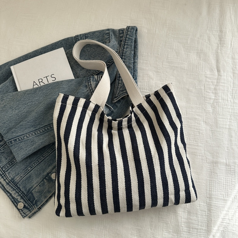 The new cross-border vertical striped commuter tote bag, hand-held shoulder bag, is fashionable and has a large capacity. It features an InS-style simple letter sail undefined