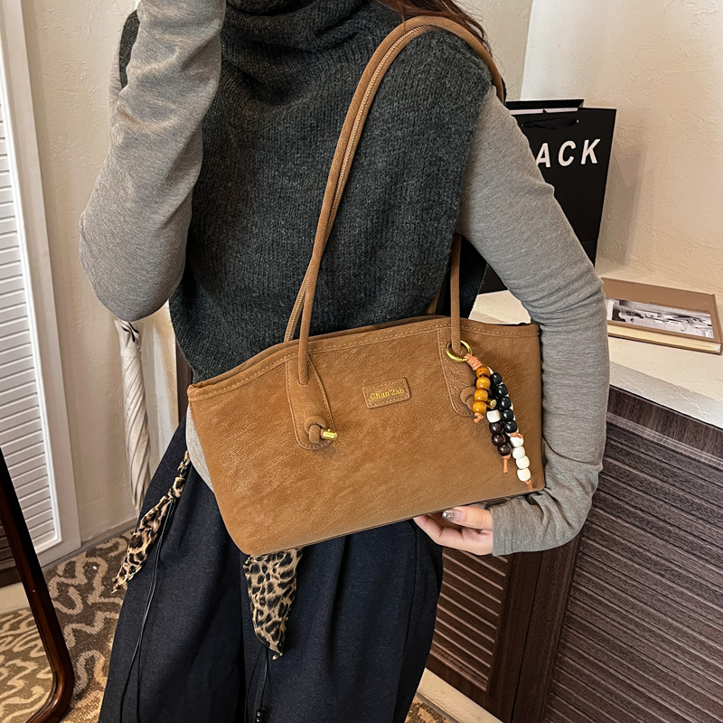 Bolsa de hombro casual coreana de nicho retro simple bolsa de brazo de viaje para mujeres 2025 nueva moda bolsa de mano