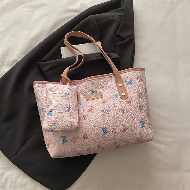 2026 flores coreanas mariposas de gran capacidad de viaje de primavera nueva moda moda extranjera bolso de hombro