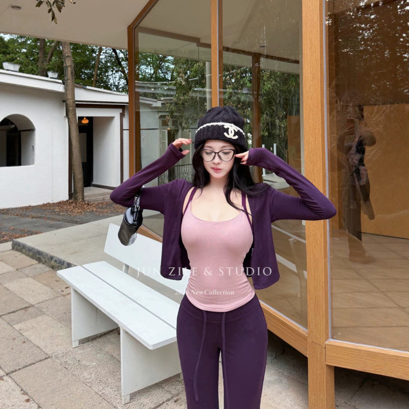 Women's autumn outfit set for the airport: casual style with a beautiful back camisole, long-sleeved cardigan, and slightly flared casual pants