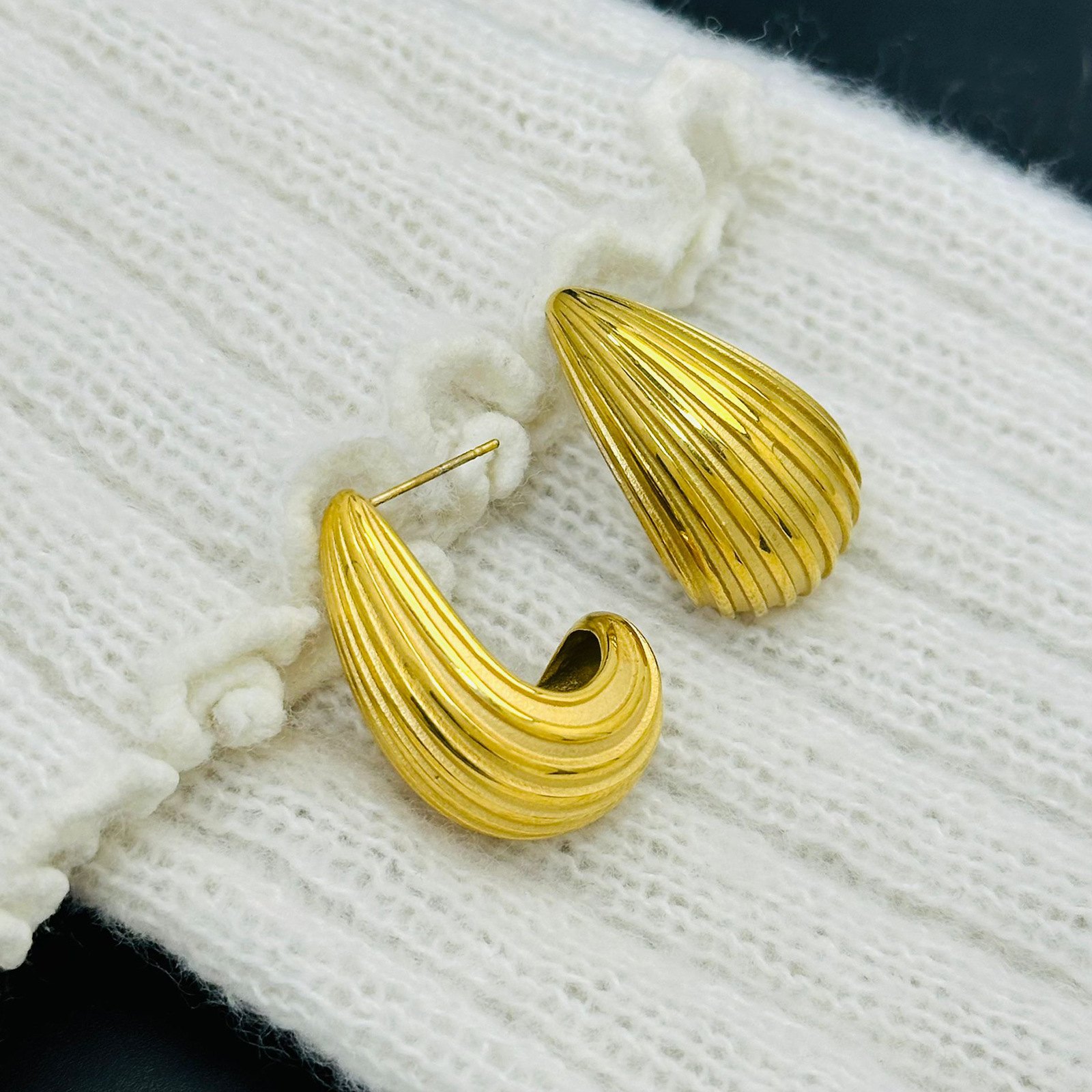 Comercio exterior Europa y Estados Unidos rayas huecas de alta calidad pernos de acero de titanio chapados en oro 18K composto textura pendientes esféricos para mujeres