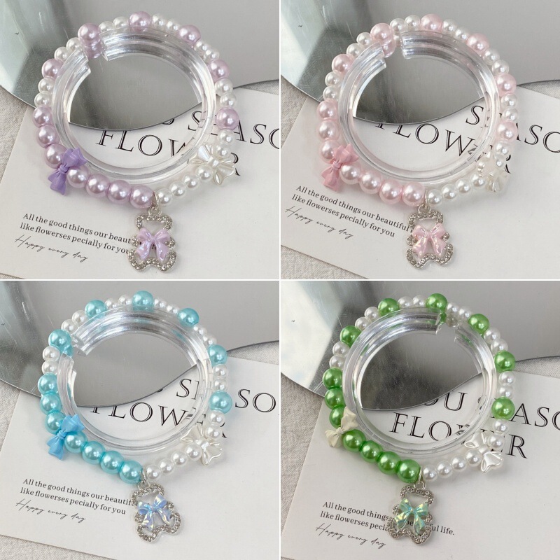 Korean-style sweet girl two-tone pearl elastic bracelet with handmade beads, bowknot, and bear pendant, wholesale from manufacturer