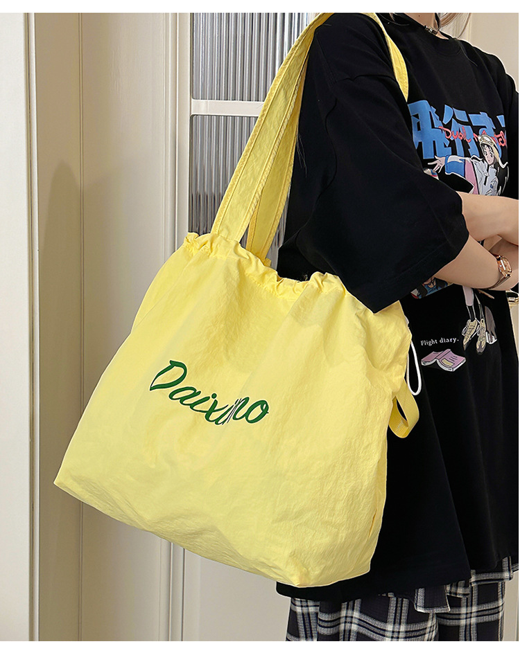 Solid color large-capacity tote bag 2025 bestseller, fashionable commuting lightweight handbag, laid-back style drawstring nylon bag for women undefined