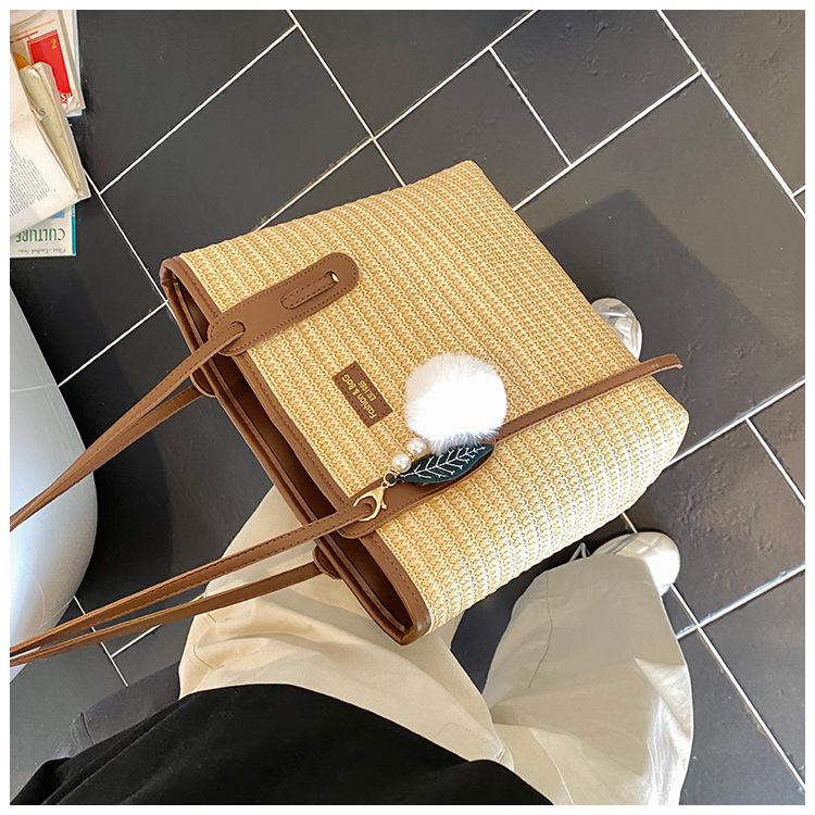 This is a new 2025 summer beach-style women's bag with a simple and versatile hand-held design. It's a single-shoulder vacation woven bag undefined