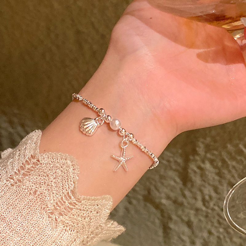 Pulsera de perlas de sentido avanzado de nicho de lujo ligero, temperamento de moda coreano femenino, pulsera de amor de circón intermitente, pulsera de cristal