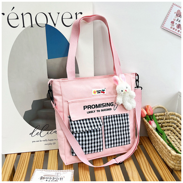 The new Korean-style cute nylon bag for class tutoring is a versatile checkered single-shoulder bag that is selling well (with a bear) undefined