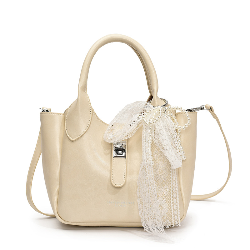 Coreano ultra caliente nicho bolso de cubo portátil para mujeres 2025 nuevo estilo de moda textura versátil alta sensación de hombro mochila