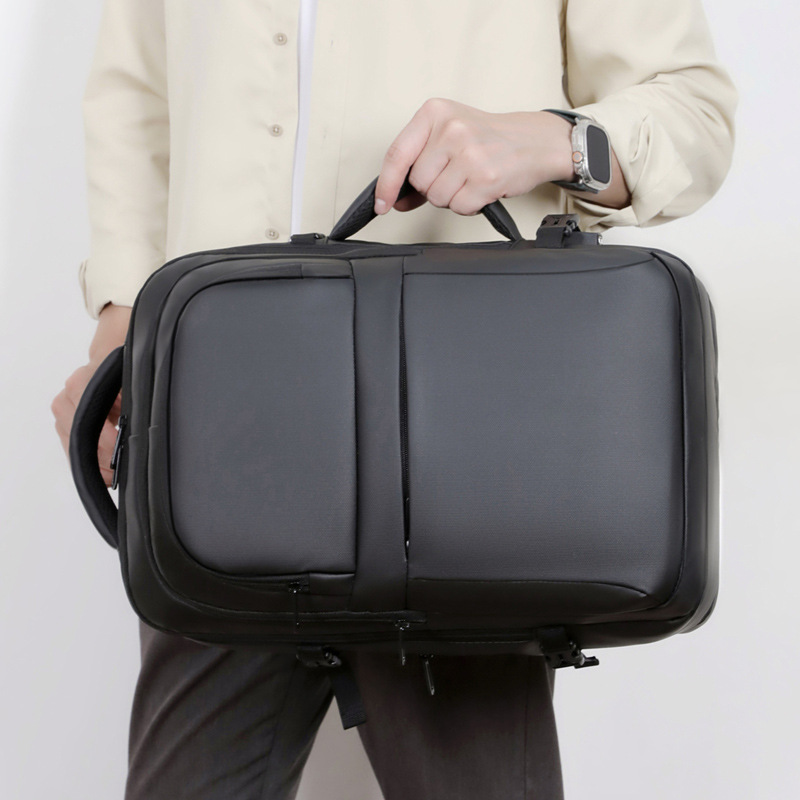 Mochila simple de color sólido de gran capacidad para hombres con capacidad de expansión multi-compartimiento USB colgando varilla de tracción mochila de viaje