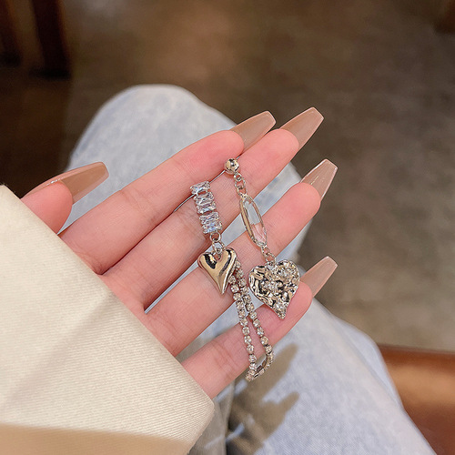 The same trendy asymmetrical heart-shaped earrings for women, made of S925 silver, with delicate light luxury and niche design, featuring micro-set zirconia.