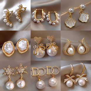 Earrings from pearl with bow, light luxury style