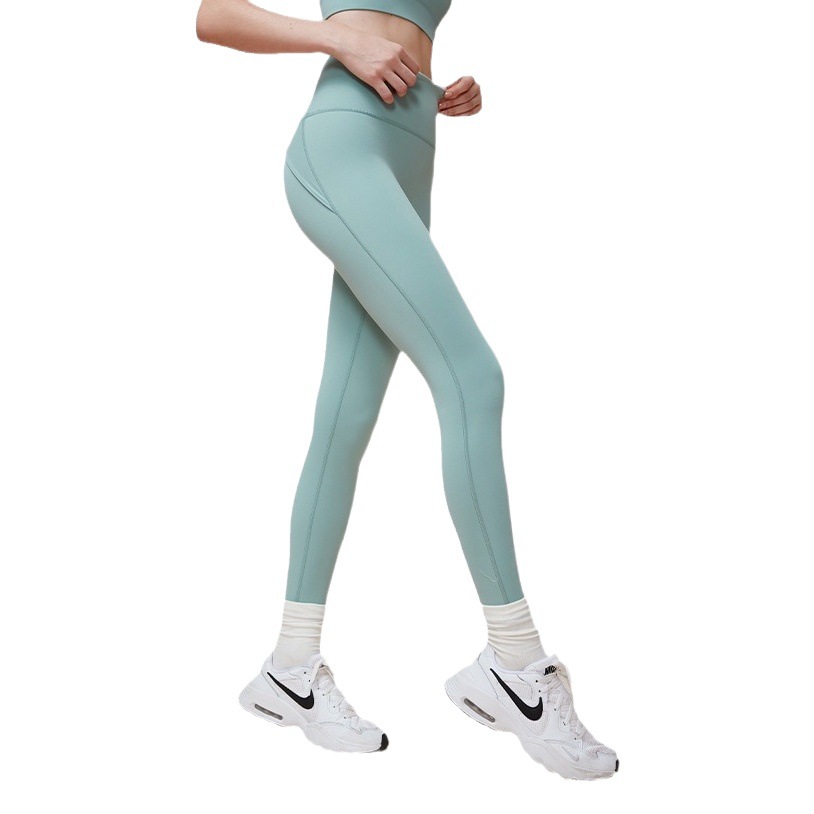 Pantalones deportivos de yoga con diseño de cintura alta y tiras cruzadas, estilo novedoso para primavera y verano, que realzan los glúteos y moldean la figura, ideales para fitness y running sin líneas incómodas.