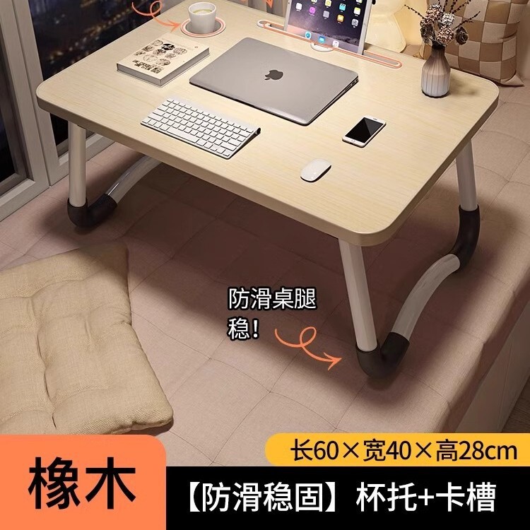 折り畳み可能なベッドの上の小さなテーブルは机のノートパソコンのテーブルを勉強します。|undefined