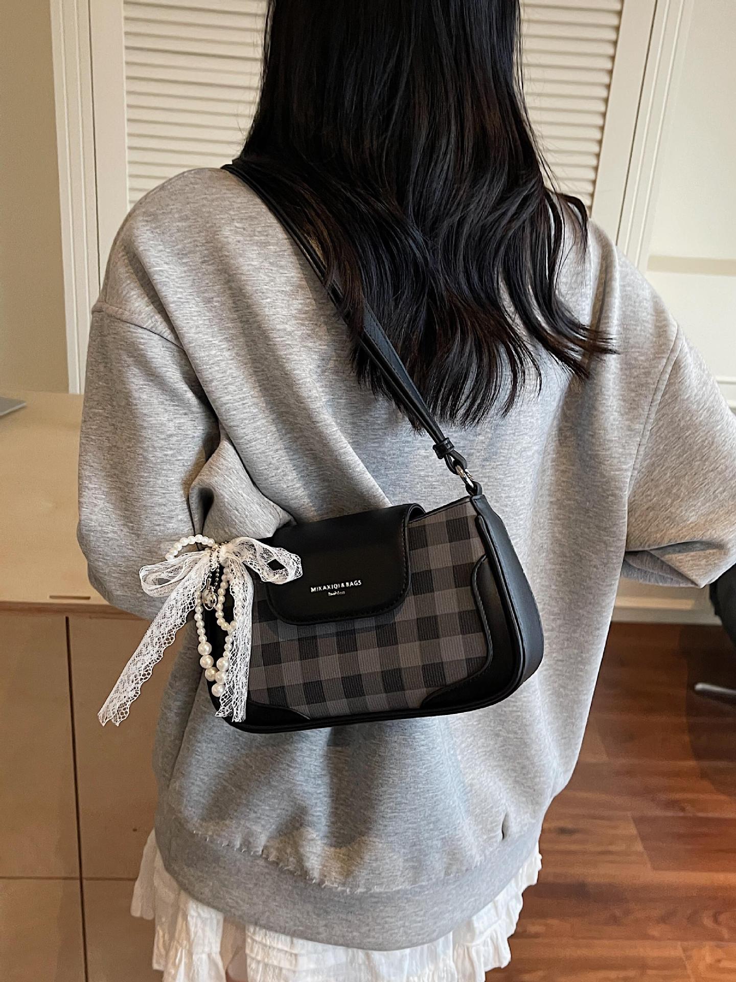 Bolso de axila de diseño de nicho a cuadros de estilo occidental 2025 nuevo bolso de hombro de todo fósforo de color en contraste bolso de mensajero de moda de alta gama