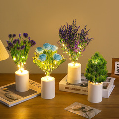 クリスマスツリーの青いバラのチューリップはアザミの花のラベンダーのヒマワリの月の季節を刺して花束の発光の小さい夜の明かりをシミュレーションします。