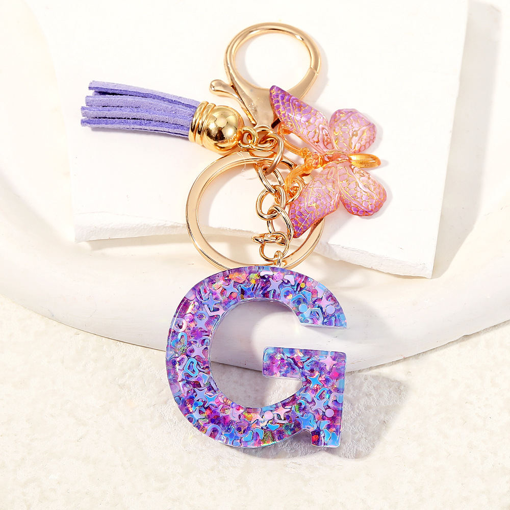 Mayorista transfronterizo mariposa esquinilla iniciales llavero de cristal goteo llavero de letras bolsos colgante