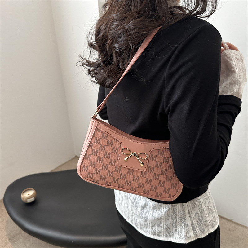 Tendencia universal bolso de hombro para mujeres 2025 nuevo estilo simple bolso de brazo de viaje de moda arco bolso de mano