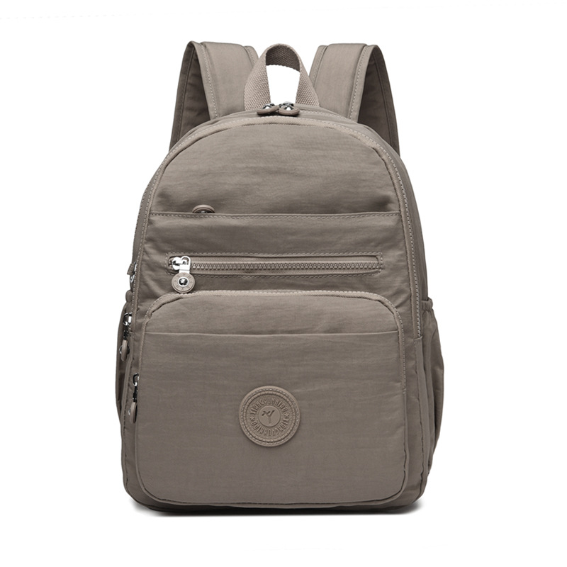 Mochila de hombro de comercio exterior 2025, nueva mochila de computadora simple de color sólido, mochila de escuela secundaria, mochila para hombres y mujeres.