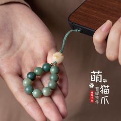 携帯電話のチェーンの縄の数珠の指の環は炭焼きの猫の爪の携帯電話の縄の手を掛けて金のペンダントの女性の金を思います。