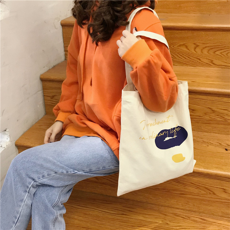 E131 canvas bag, Korean-style ins hand-held shoulder bag, color block letter graffiti shopping bag, female student's search for sources undefined